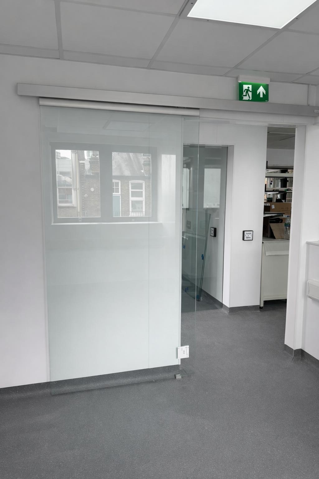 Frosted glass automatic sliding door installed in an office interior