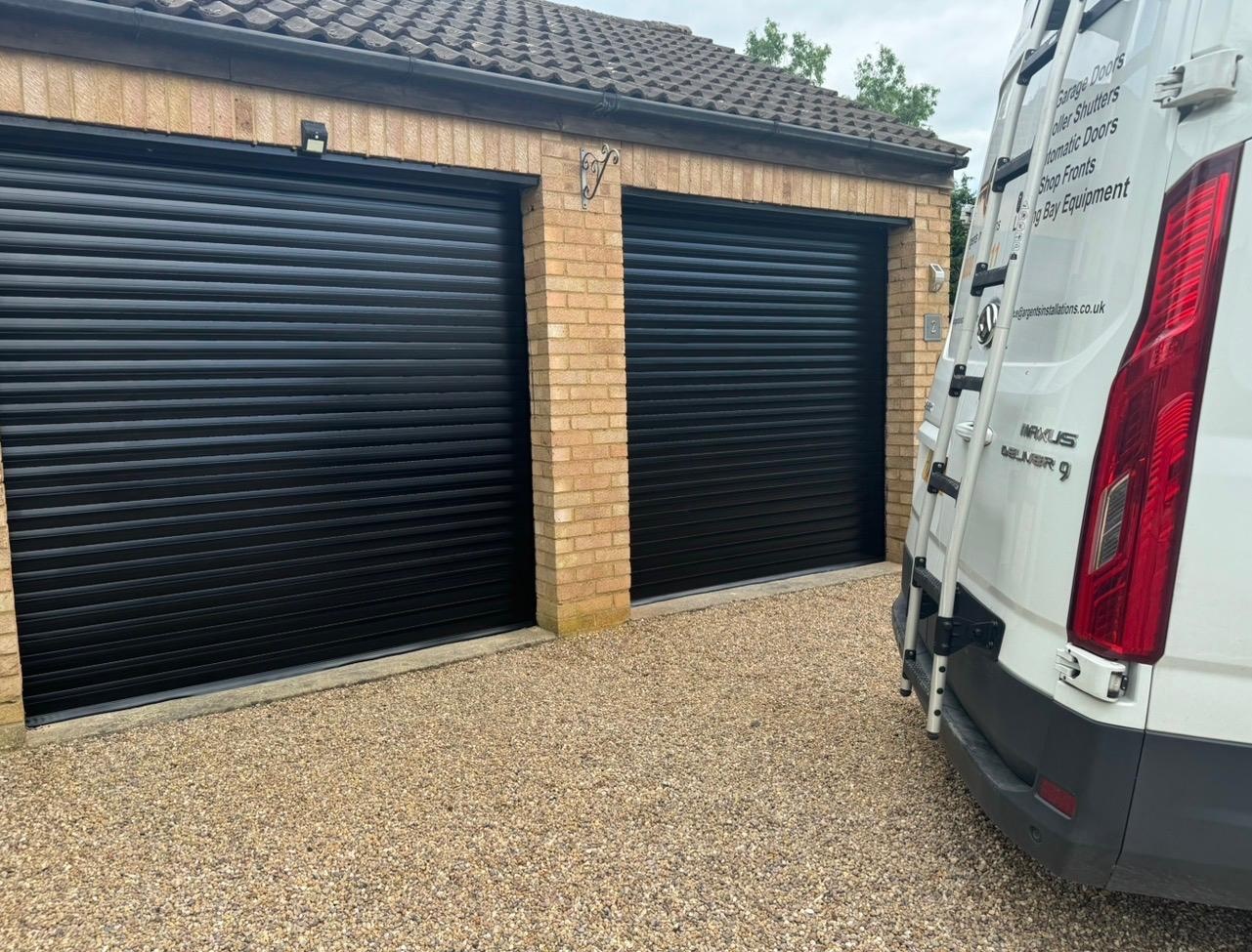 Black roller garage doors installed at commercial premises