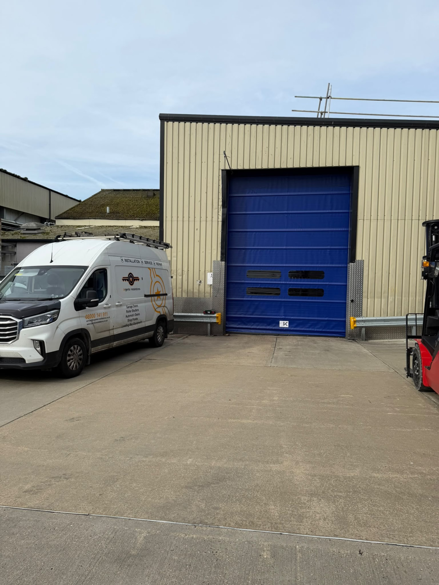 Blue high speed door installed at a warehouse loading bay