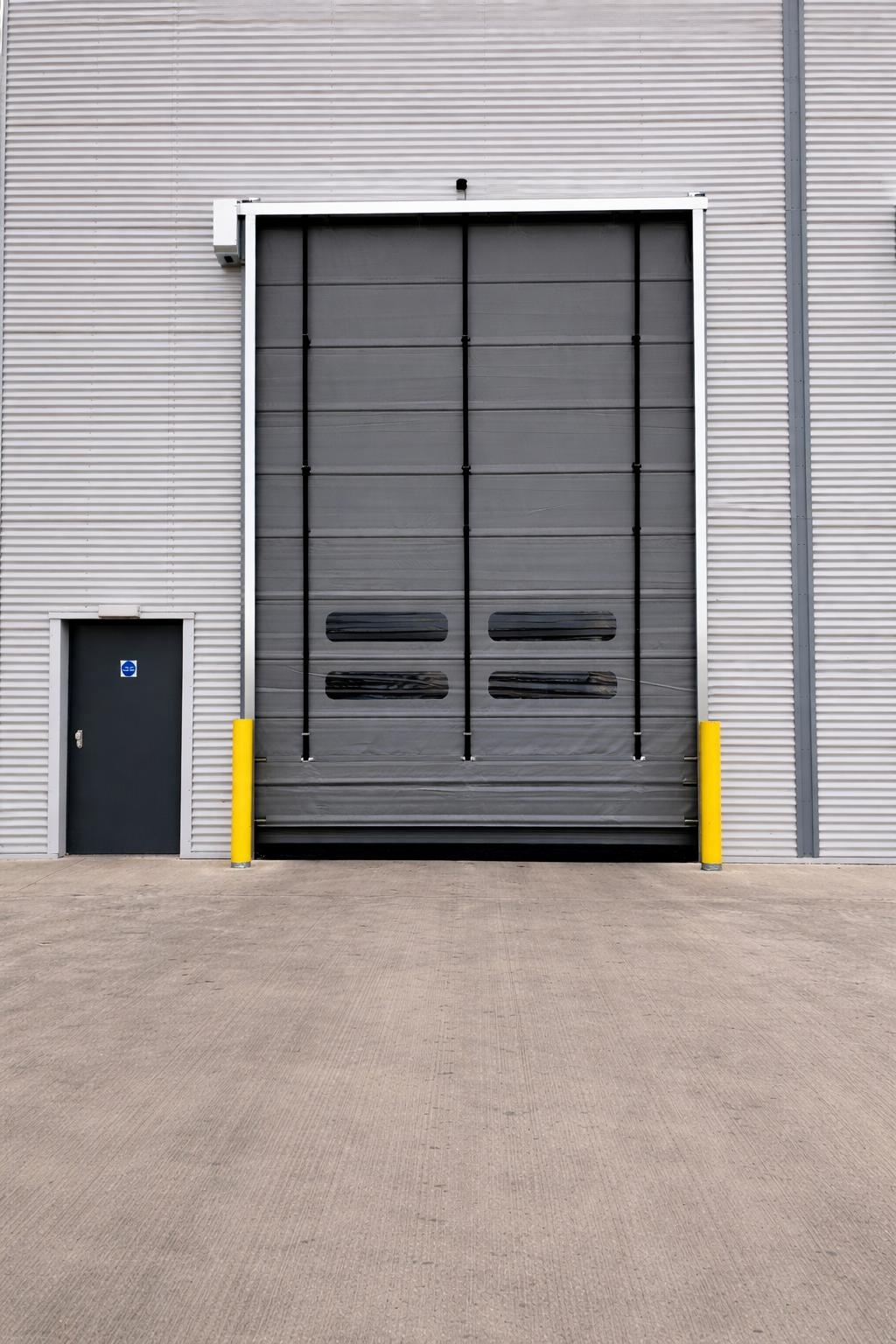 Grey high speed industrial door on a steel clad warehouse wall