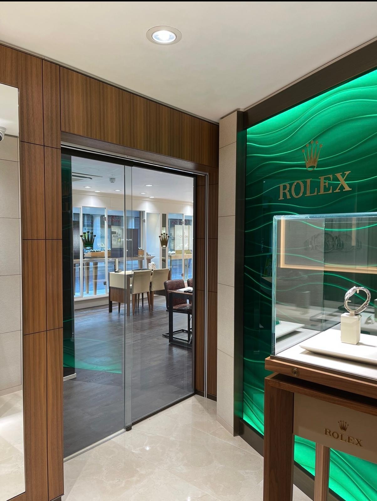 Automatic sliding glass entrance doors installed at a commercial shop front