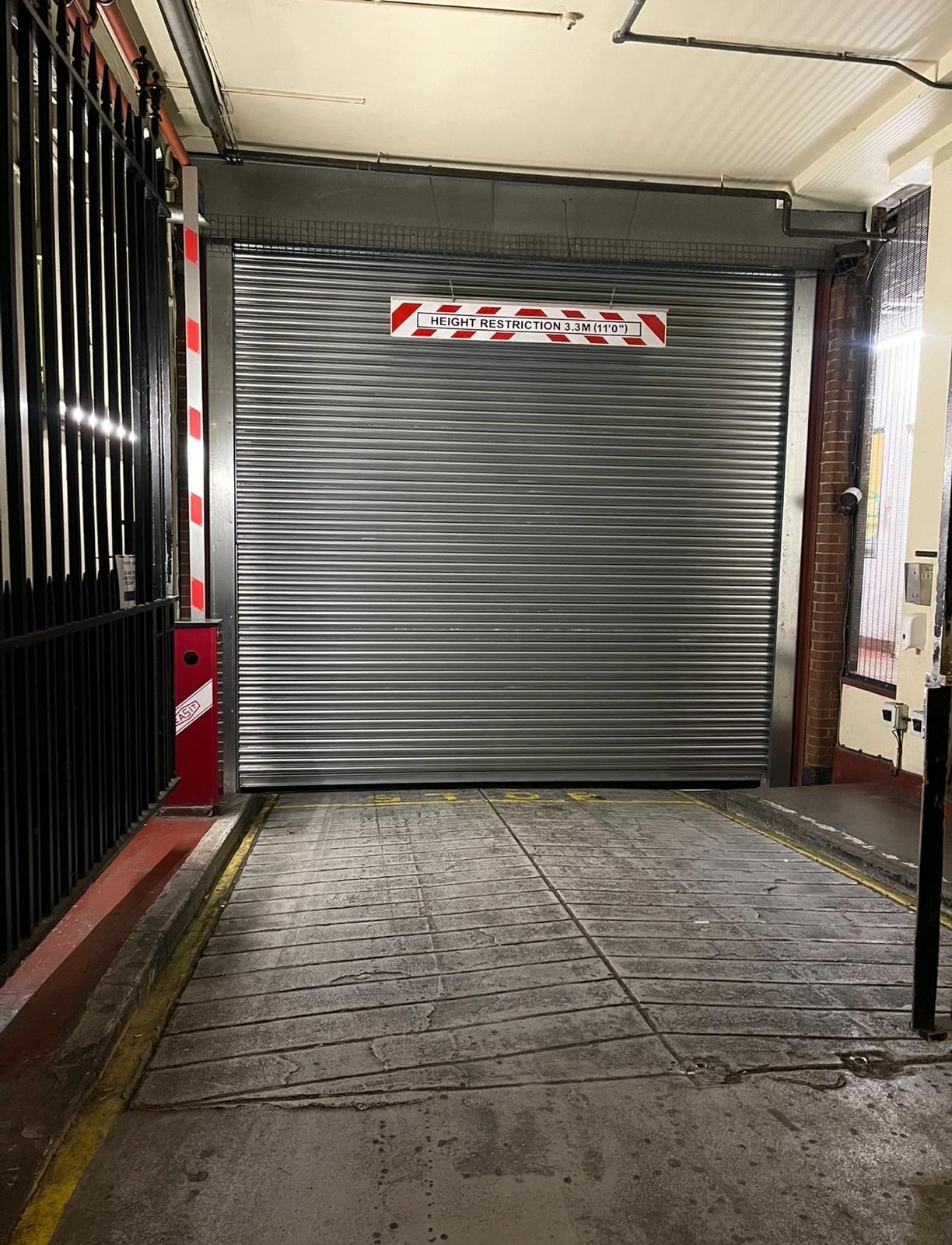 Steel roller shutter door securing a parking garage entrance