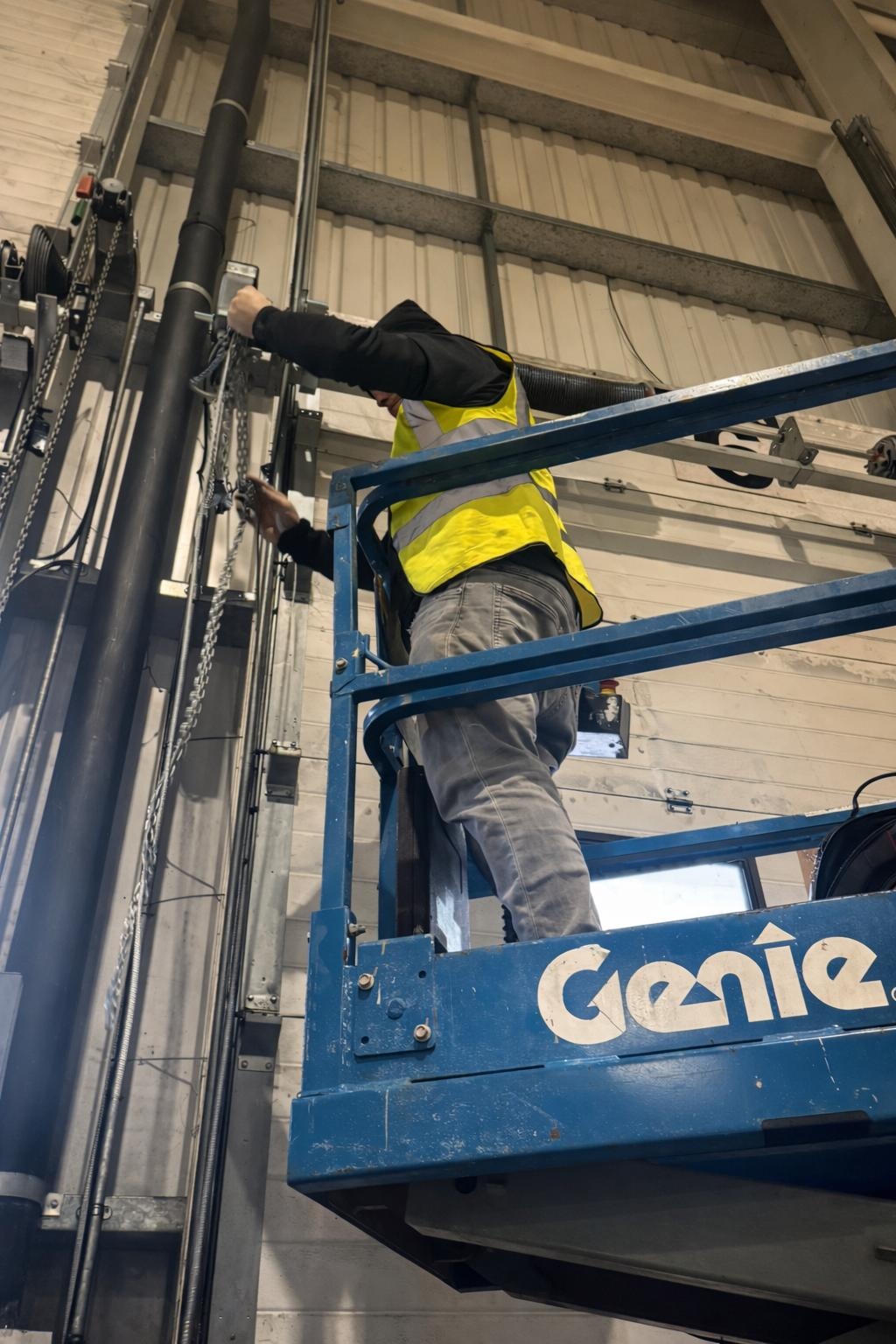 Argents Installations engineer on an access platform installing loading bay door gear