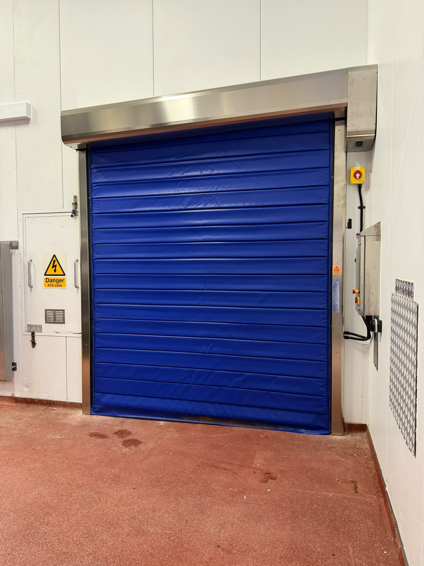 Blue high speed industrial door installed in a temperature controlled facility